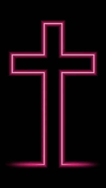 a neon pink cross on a black background