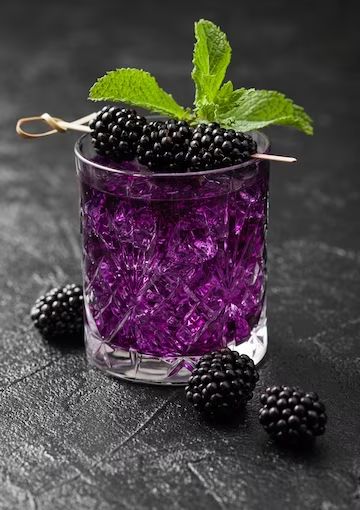 blackberries in a glass with ice and mint