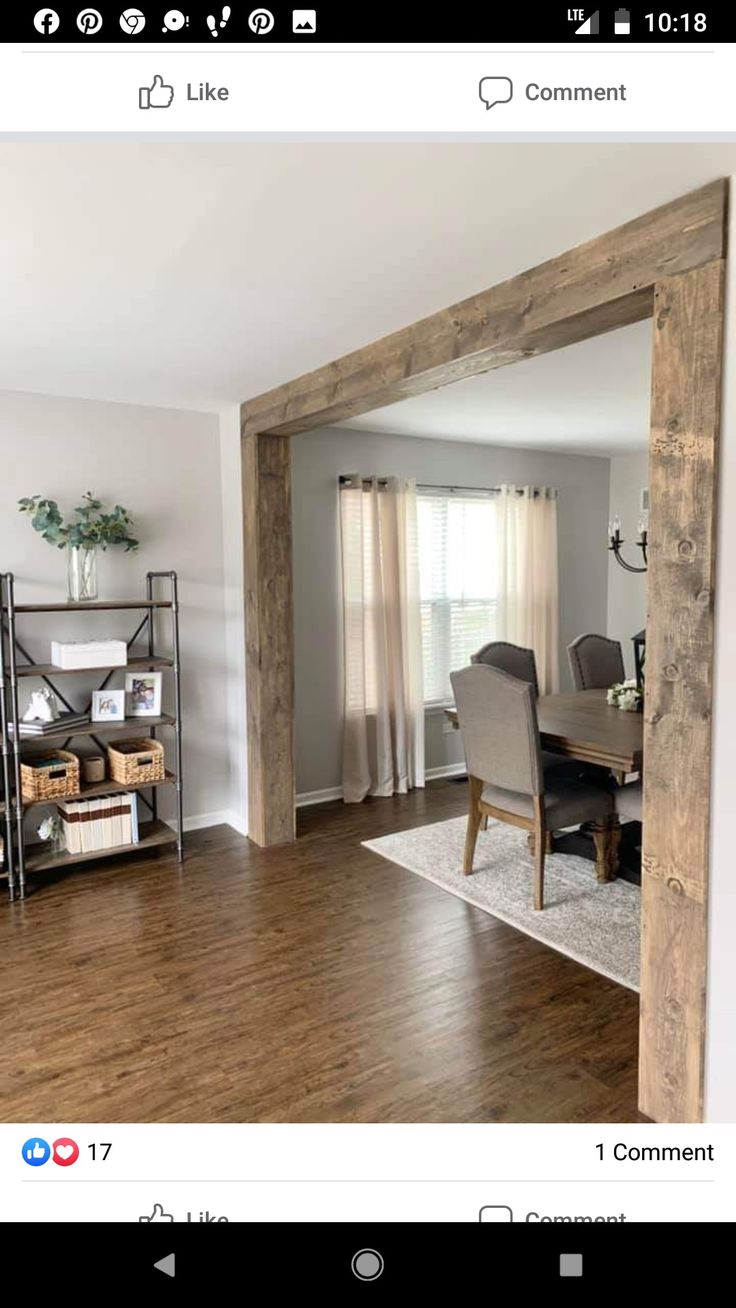 an open living room and dining room with wood flooring on the walls, wooden beams in the ceiling