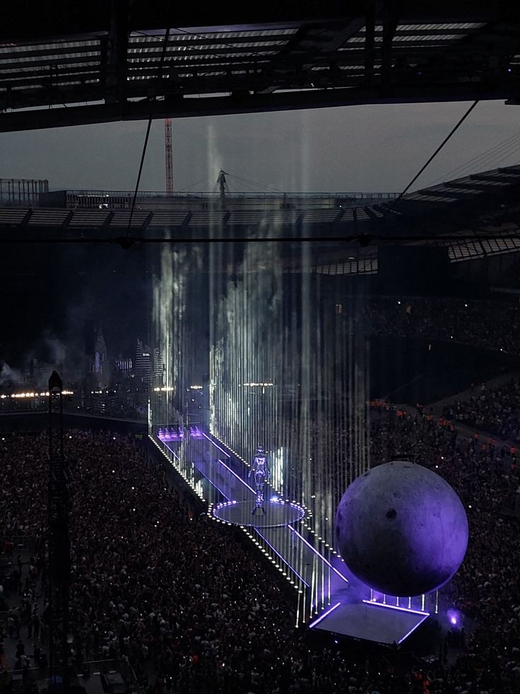 the stage is lit up with purple lights