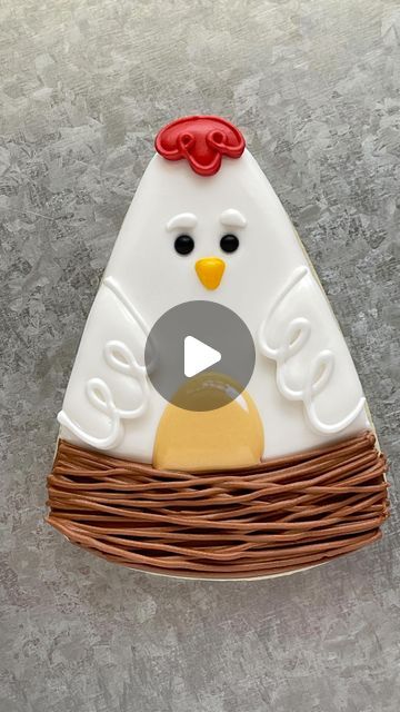 a white and brown chicken sitting on top of a table