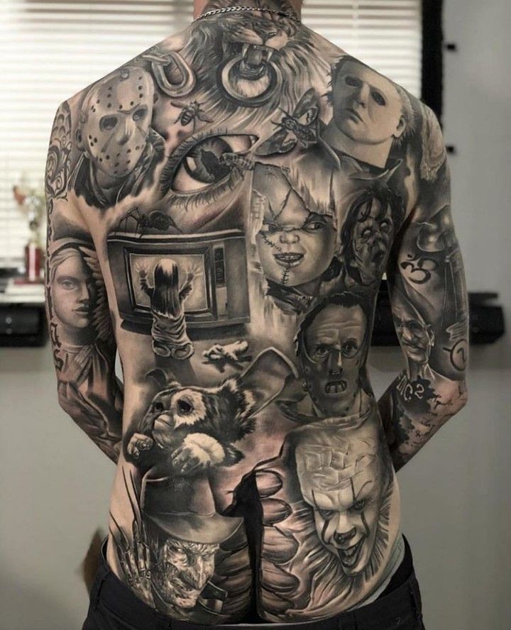 the back of a man's body with many different tattoos on his upper and lower half