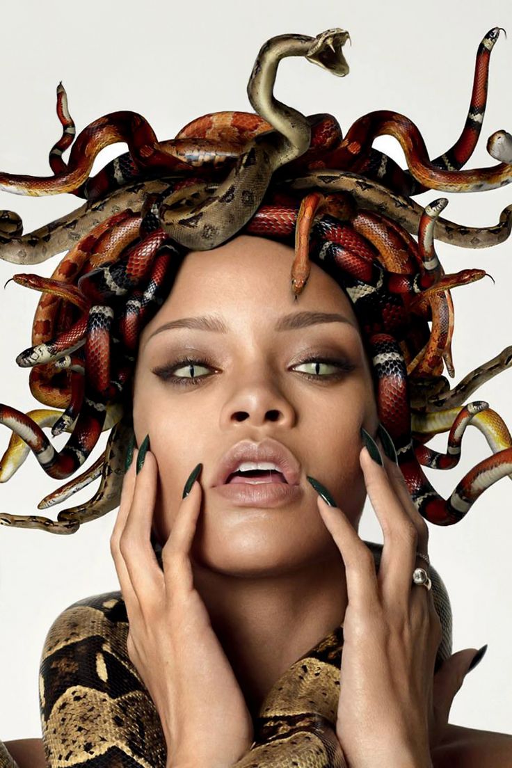 a woman with snakes on her head holding her hands to her face and looking at the camera