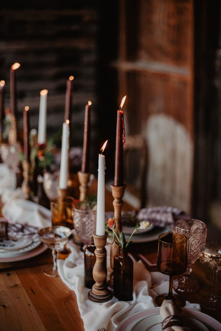 the table is set with candles and dishes