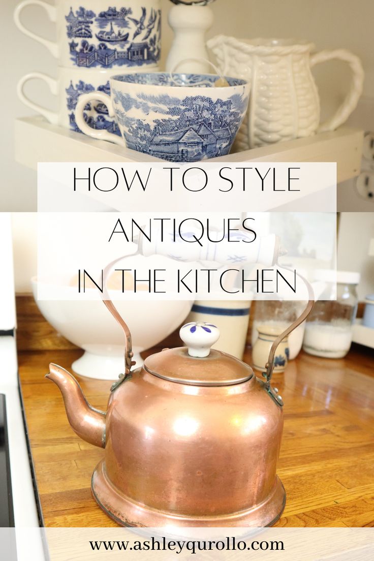 an old tea kettle sitting on top of a kitchen counter with blue and white dishes