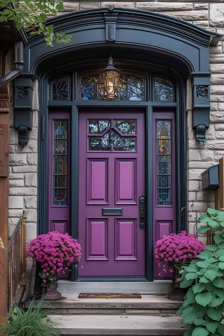 a purple front door with two pink flowers on the steps