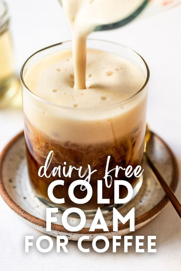 dairy - free cold foam for coffee is being poured into a glass on a plate