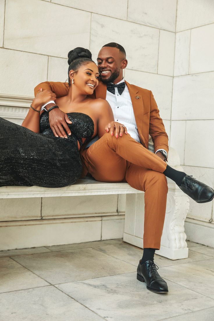 a man and woman are sitting on a bench