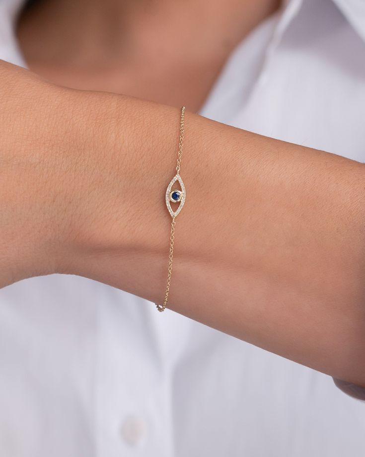 Beautifully handcrafted 14k gold evil eye bracelet with pave diamond and a blue sapphire center. Uber chic and timeless, available in yellow, white and rose gold, perfect solo or stacked. Size of Evil Eye: Approx. 13mm(W) by 6mm(H) Chain Length: 6" - 7" Adjustable Diamond Carat Weight: Approx. 0.06 (ct. tw) Blue Sapphire Carat Weight: Approx. 0.07 (ct. tw) Total Weight: Approx. 1 gram Ships in 4-7 business days Rush orders ship in 2-4 business days Comes gift ready in a custom Zoe Lev jewelry bo Evil Eye Dainty Jewelry, Delicate Bracelet Diamond, Delicate Diamond Jewelry, Silver Hand Bracelet, Evil Eye Gold Bracelet, Evil Eye Jewelry Bracelet, Evil Eye Bracelet Silver, Evil Eye Bracelet Gold, Silver Evil Eye Bracelet