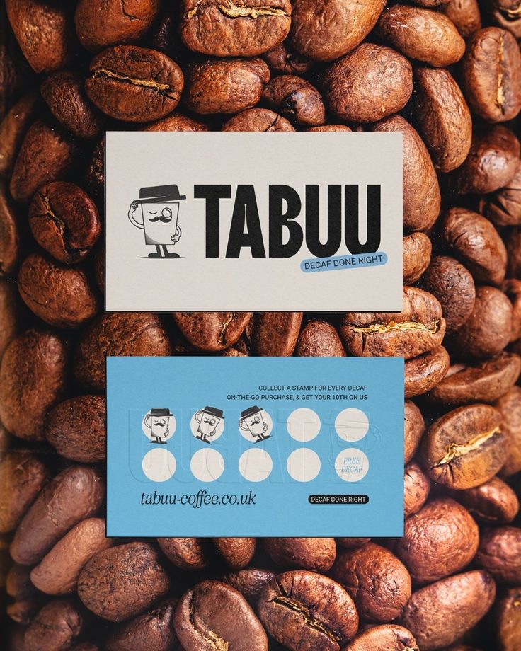 a pile of coffee beans sitting next to each other on top of a blue and white sign