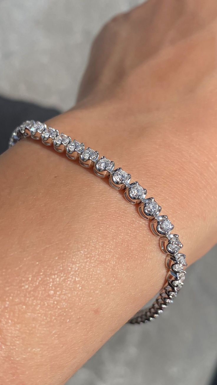 Up for sale is a Beautiful 14K Diamond Tennis Bracelet Prong Set *All specifications are for 7 Inches Specifications: -Model #: 6998 -Size of Diamonds: 2.8 MM -Width of Bracelet: 4 MM -Height of Bracelet: 2.8 MM -Gold Weight: 8.8 Grams -Total Diamond Weight: 45 Round 4.00 Carats -Color: F -Clarity: SI *18K GOLD & PLATINUM ALSO AVAILABLE WITH ADDITIONAL COST CUSTOM MADE TO ORDER Brief Overview: -30 Day Return Policy -Conflict Free Diamonds -Satisfaction Guarantee -Box Included With Purchase. Tennis Bracelet Diamond For Women, Hockey Wife, Classic Jewelry Pieces, Diamond Bracelet Design, Mens Silver Jewelry, Basket Setting, Diamond Tennis Bracelet, White Gold Bracelet, Women's Jewelry And Accessories