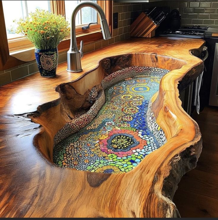 a sink made out of wood and glass in the middle of a kitchen counter top