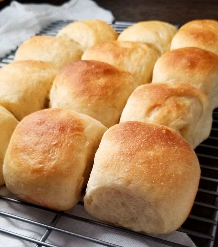 bread rolls sitting on top of a cooling rack