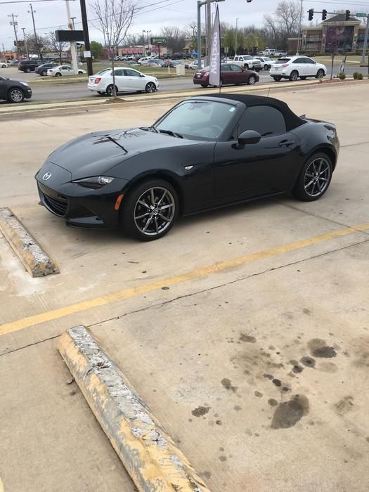 a black sports car parked in a parking lot