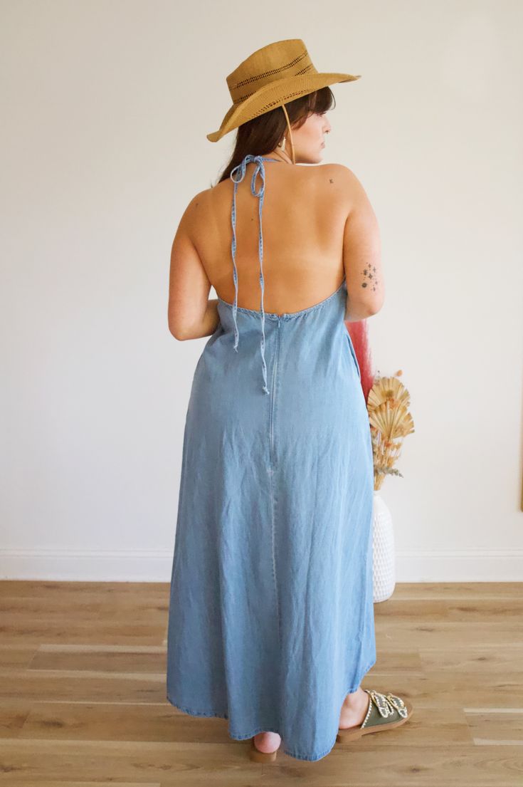 Elevate your style with our Denim Blue Maxi Dress! This halter maxi is made with light weight denim, perfect for any summer occasion. Plus, it features pockets and a low back, making it both stylish and practical. Complete with a zipper in the back for easy wear. Summer Maxi Dress With Pockets For Day Out, Summer Denim Dress With Pockets, Casual Cotton Halter Neck Maxi Dress, Casual Maxi Length Halter Dress For Day Out, Casual Backless Denim Dress, Casual Maxi Halter Dress For Day Out, Denim Blue Summer Vacation Dress, Casual Blue Backless Maxi Dress, Medium Wash Summer Dress For Vacation