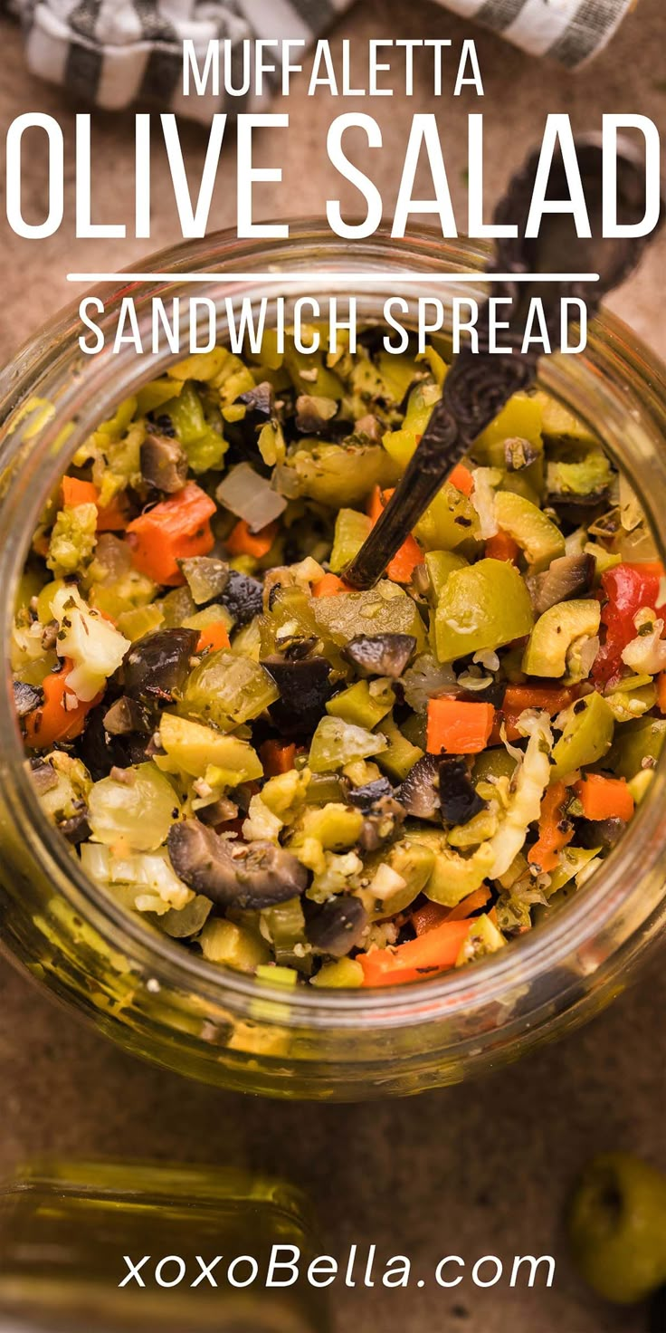 a glass bowl filled with olives and vegetables