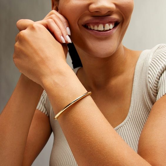 Sleek and refined, this sculpted gold open bangle bracelet is a sophisticated choice for day or night. Hollow 14K gold The open bangle simply shines in a polished finish 7.25 inches in circumference; flexes on and off for easy wear Timeless Open Cuff Bangle With Polished Finish, Elegant Open Band Cuff Bracelet, Classic Gold Open Cuff Bracelet, Elegant Open Cuff Bangle With Polished Finish, Everyday Polished Yellow Gold Cuff Bracelet, Elegant Gold Open Band Bangle, Elegant Open Band Bangle For Formal Occasions, Elegant Open Band Formal Bangle, Elegant Formal Open Band Bangle