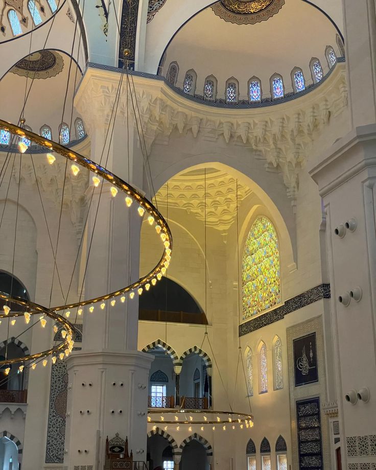 the inside of a large building with chandeliers hanging from it's ceiling