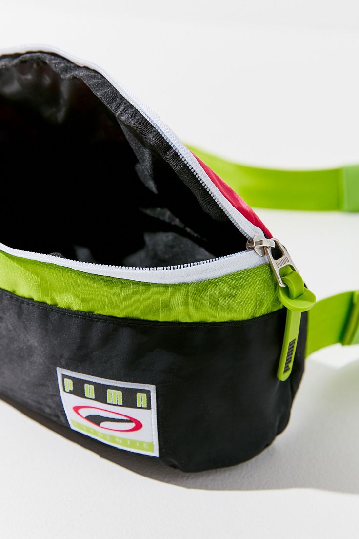 Perfect for giving your off-the-clock looks an instant does of street style, this PUMA fanny pack stands out from the crowded field of belt bags with sporty and vibrant colorblocking. DETAILS Fabric: Technical weave Rubber zip tassels Logo patch Zip at top Lined Weight: 5oz / 0.14kg Imported Measurements Height: 4.25in / 11cm Length: 13.5in / 34cm Depth: 3.5in / 9cm Belt length: 26.75-42.25in / 68-107cm Sporty Green Belt Bag For Travel, Green Nylon Belt Bag With Removable Pouch, Sporty Crossbody Belt Bag With Cell Phone Pocket, Sporty Nylon Belt Bag For Outdoor Activities, Sporty Belt Bag With Removable Pouch For Outdoor Activities, Sporty Belt Bag With Adjustable Strap For Outdoor Activities, Green Belt Bag With Removable Pouch For Outdoor Activities, Green Belt Bag With Removable Pouch For Outdoor, Sporty Black Crossbody Belt Bag