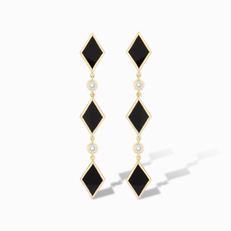 Turn heads with our Diamonds Do Sparkle Statement Earrings in striking black onyx. These captivating drop earrings blend timeless sophistication with a modern edge, featuring a series of playful diamond shapes interspersed with shimmering cubic zirconia accents. The sleek black and gold design exudes elegance, while the pop of sparkle adds a touch of glamour to any ensemble. Perfect for those who love to make a statement, these earrings will elevate both everyday looks and evening wear. Embrace Black Beaded Jewelry, Black Onyx Stone, Sparkle Earrings, Happy Vibes, Onyx Stone, Diamond Shaped, Drop Earring, Diamond Shape, Gold Design