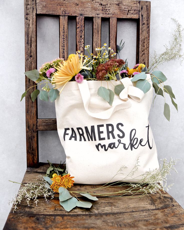 Our 100% cotton canvas farmers market tote bags are perfect for everyday use! These beautiful natural canvas shopping bags are great for a quick run to the grocery store or the local farmers market. Silly and unique, these eco-friendly handbags are a must-have for carrying fresh fruits and vegetables, books, clothes, accessories and many more! #cottonandcanvasco #totebag #tote #fall #autumn #giftideas #farmersmarket #giftsforher #homedecor #fallvibes #shoulderbag #ecofriendly #shoppingbag Cotton Canvas Tote Bag For Market, Handmade Canvas Bag For Market, Eco-friendly Canvas Shopping Bag, Cricut Farmers Market Bag, Farmers Market Canvas Bags, Farmers Market Tote Bag, Eco Friendly Handbags, Bag Photography, Fantasy Party