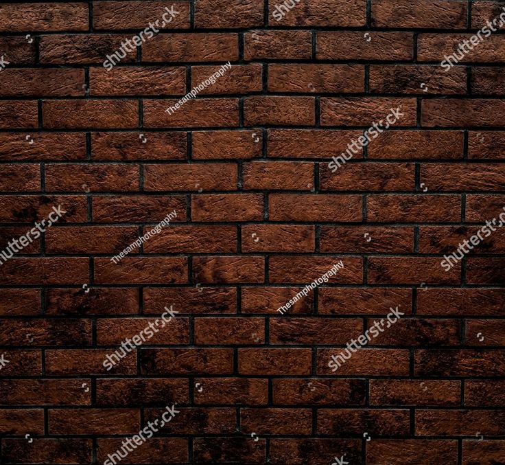 a brown brick wall textured with dark stains