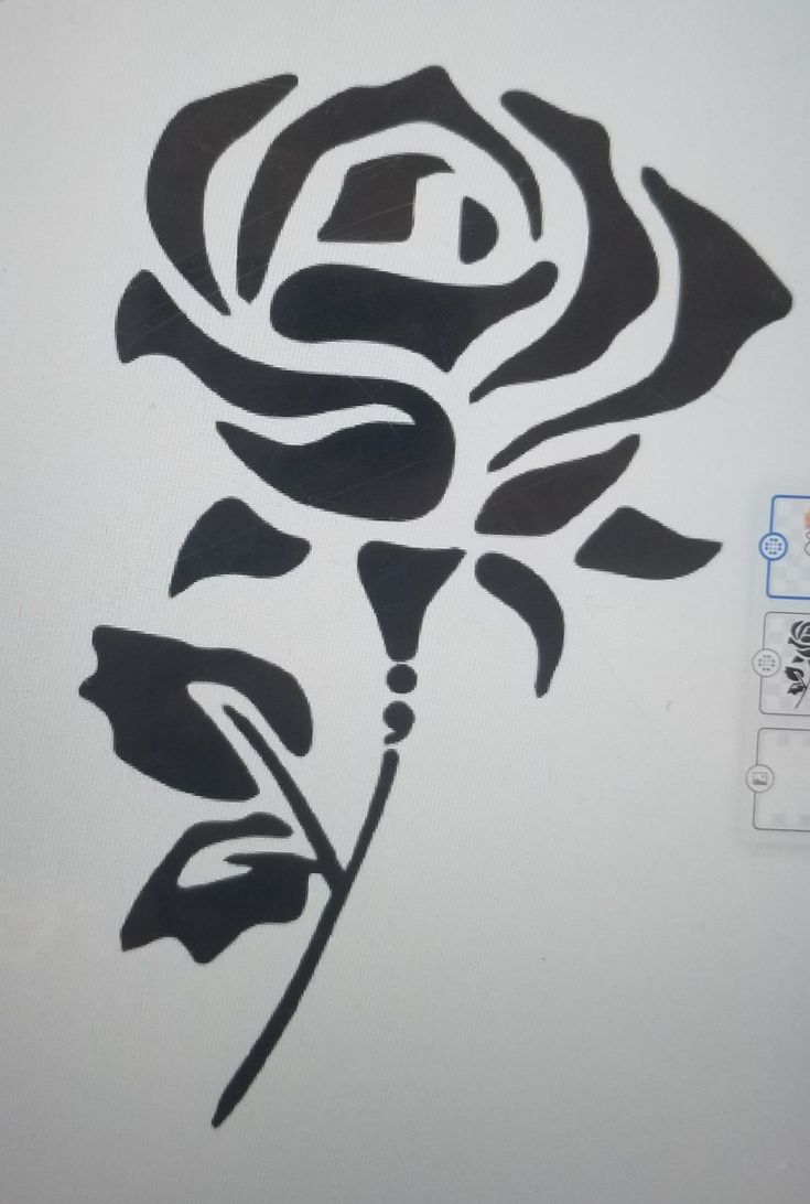 a drawing of a black rose on a white wall