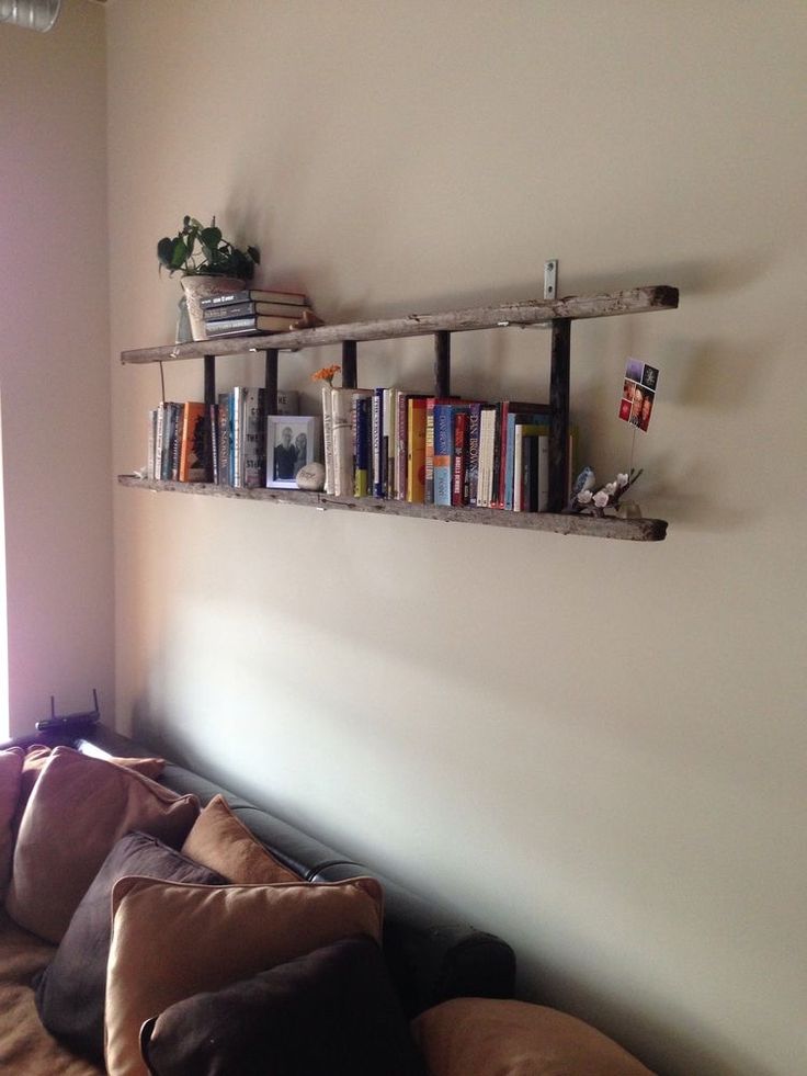 a living room with a couch, bookshelf and window