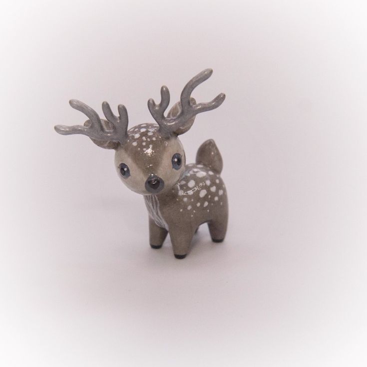 a small figurine of a deer with antlers on it's head