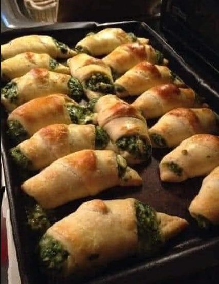 a pan filled with spinach and cheese pastries