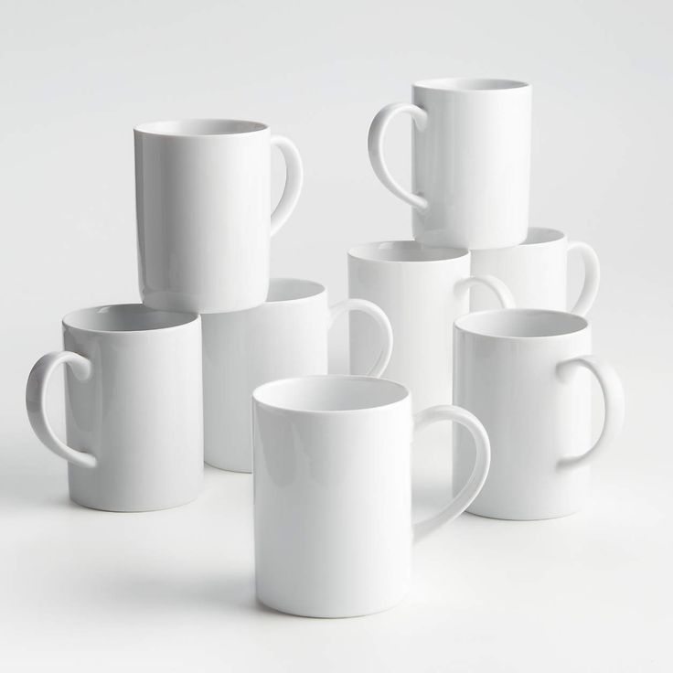 several white coffee mugs stacked on top of each other