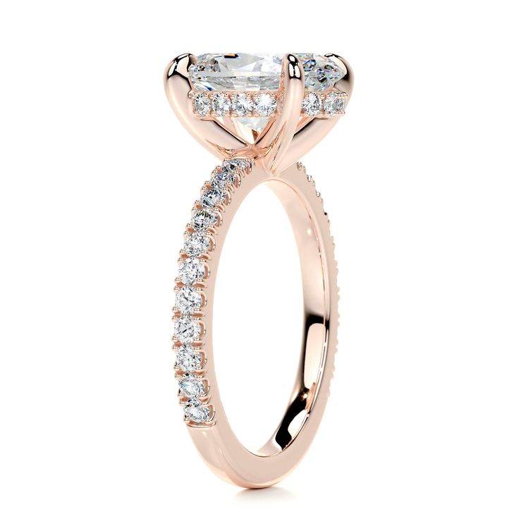 a yellow gold engagement ring with an oval cut diamond in the center and side stones