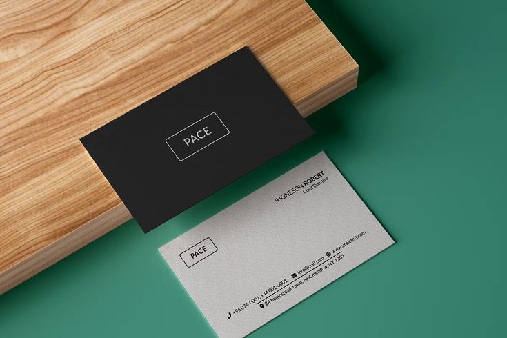 a business card sitting on top of a wooden table