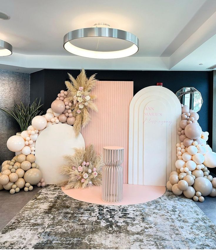 a room filled with lots of balloons and decorations on top of carpeted flooring