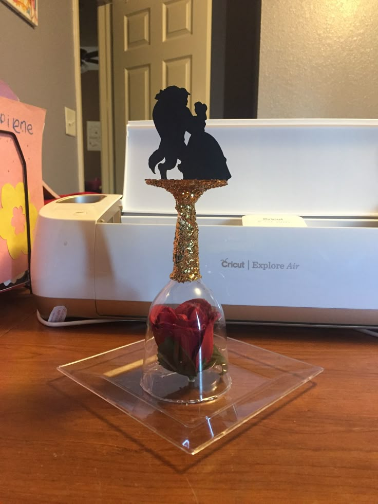 a glass vase sitting on top of a wooden table