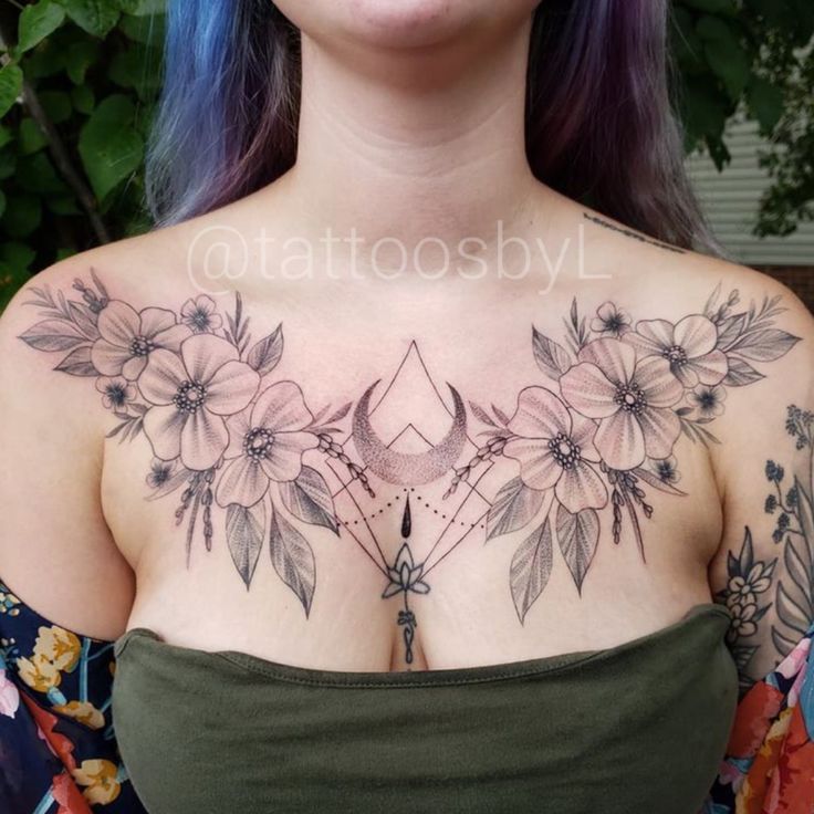 a woman with purple hair and tattoos on her chest