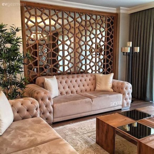 a living room filled with furniture and a large window covered in bamboo screen dividers