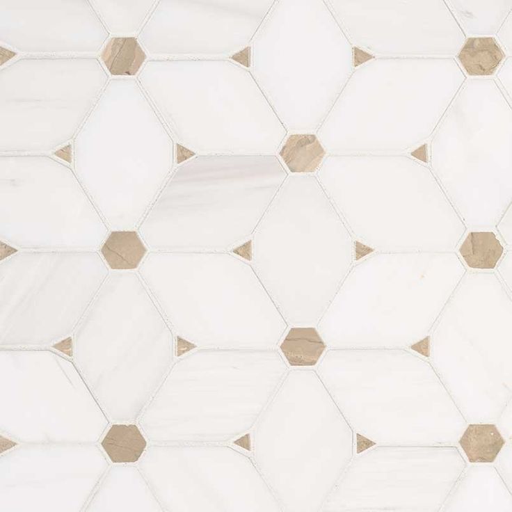 a white and gold tile pattern with hexagonals on it's sides