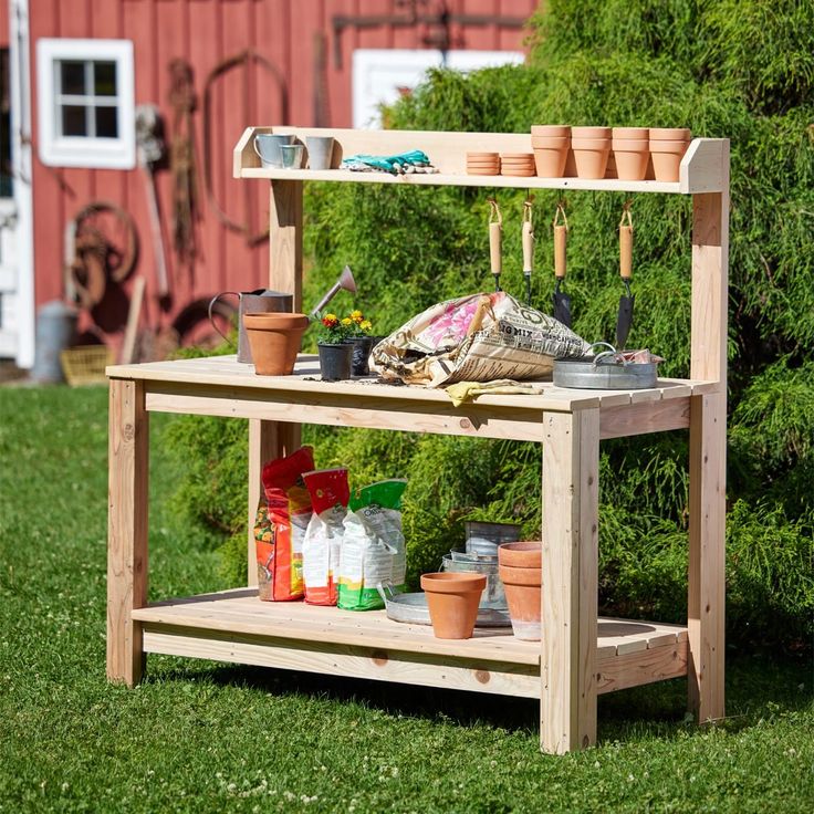 a potting bench with pots and gardening tools on it