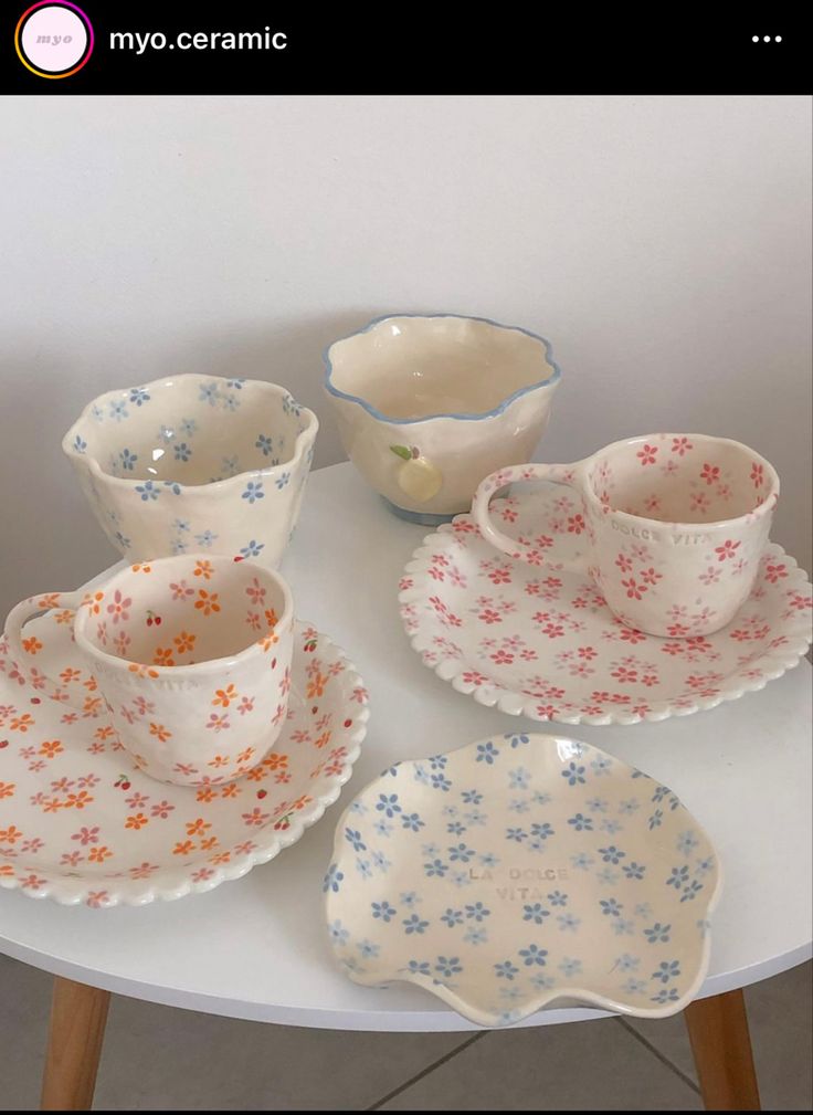 an assortment of dishes and cups on a table