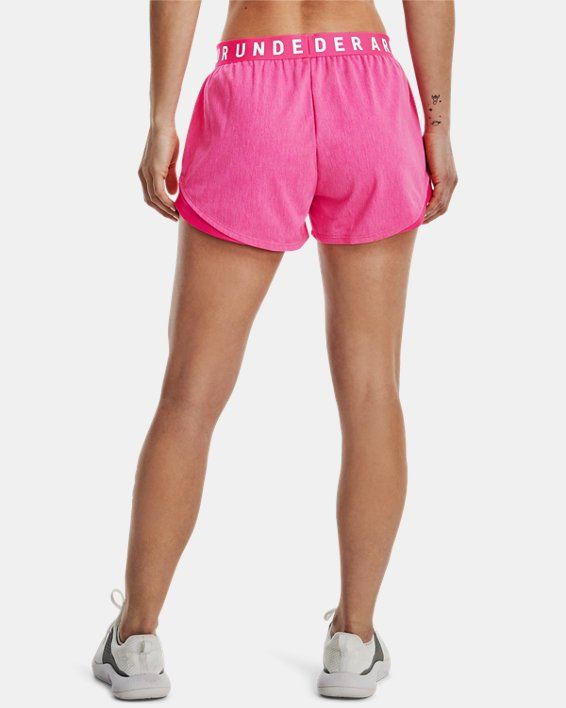 a woman in pink shorts with the word thunder written on her stomach and back side view