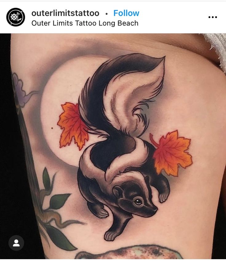 a woman's thigh with an image of a squirrel and maple leaves on it