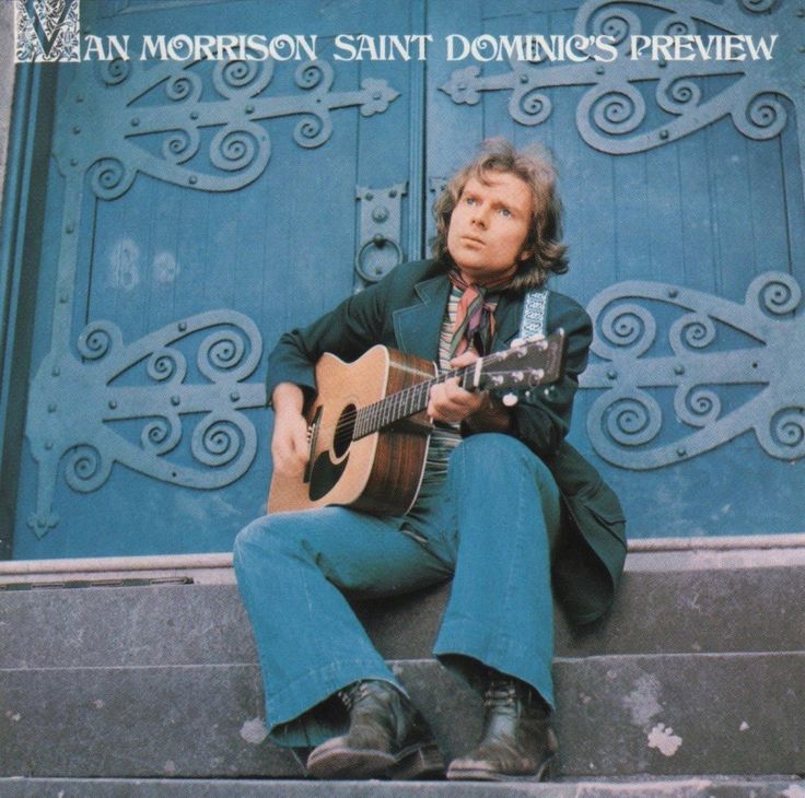 a man sitting on steps with a guitar in front of a blue door that says, an morrison saint domino's review