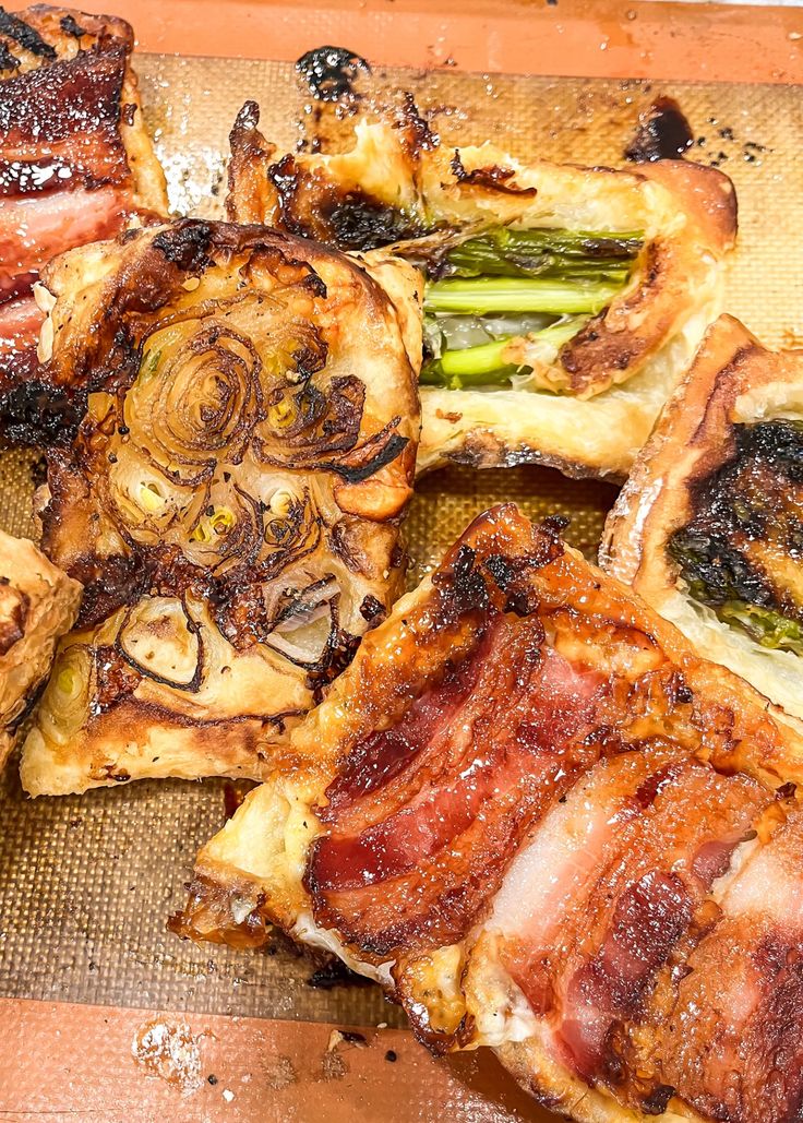 bacon and asparagus are on top of some toasted pastries that have been cut in half