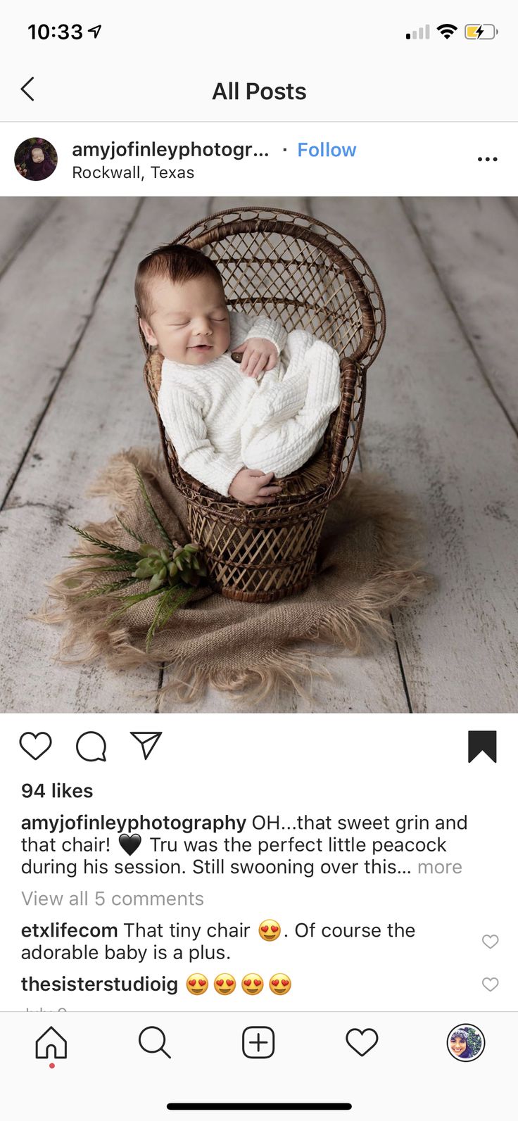 a baby in a basket on top of a wooden floor next to an instagram post