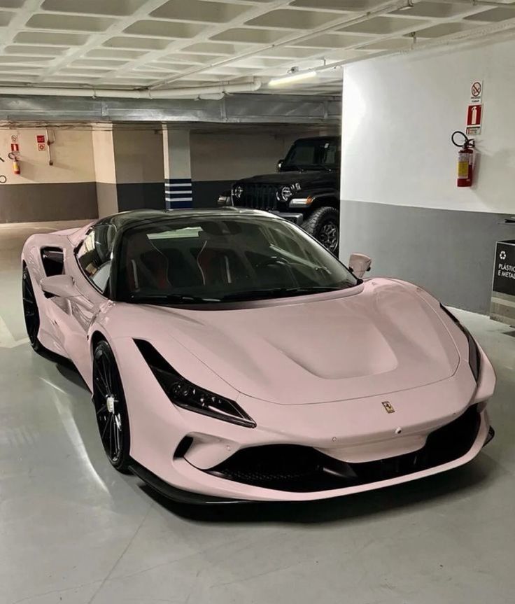 a pink sports car parked in a garage