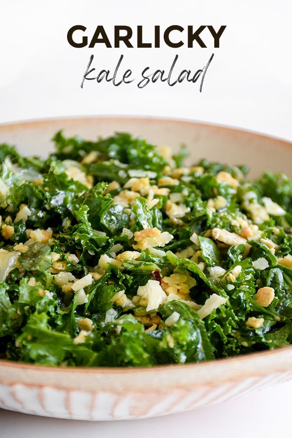 a close up of a bowl of food with broccoli and nuts in it