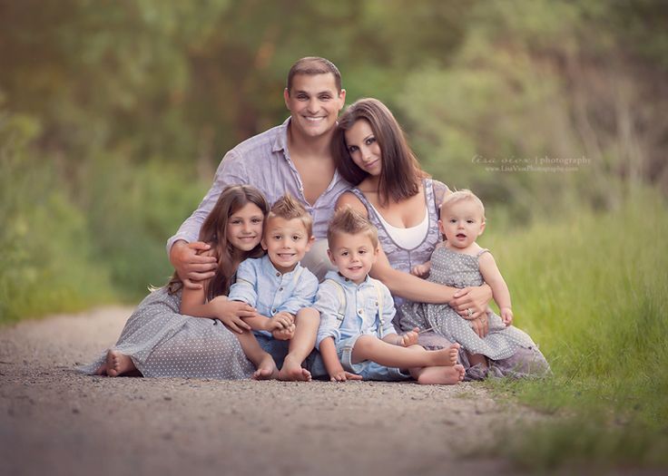 a man and woman with two children posing for a family photo