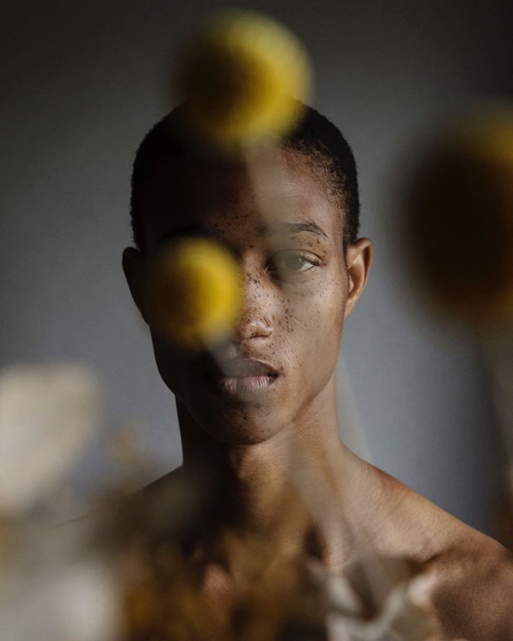 a young man is surrounded by yellow balls