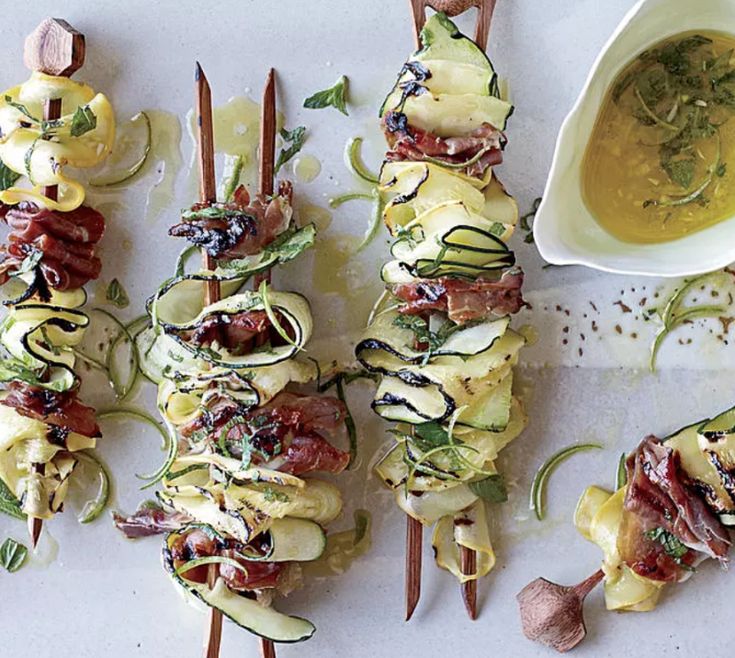 several skewered food items are sitting on a tray